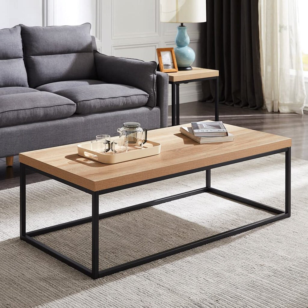 Light wood coffee table with a black metal frame in front of a grey sofa
